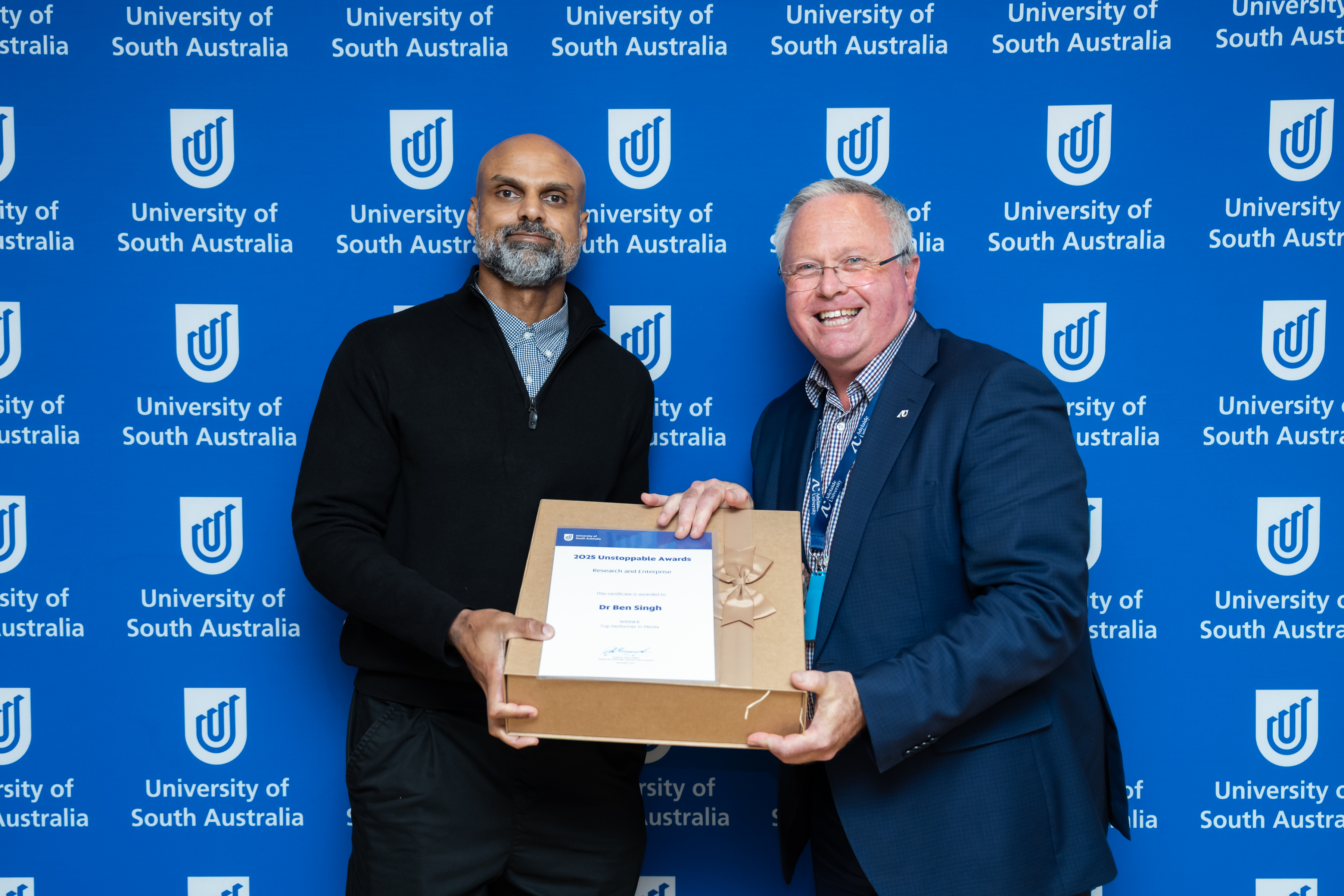 Dr Ben Singh is awarded the UniSA 2025 Top Media Performer by the Deputy Vice Chancellor: Research & Enterprise, Professor Peter Murphy