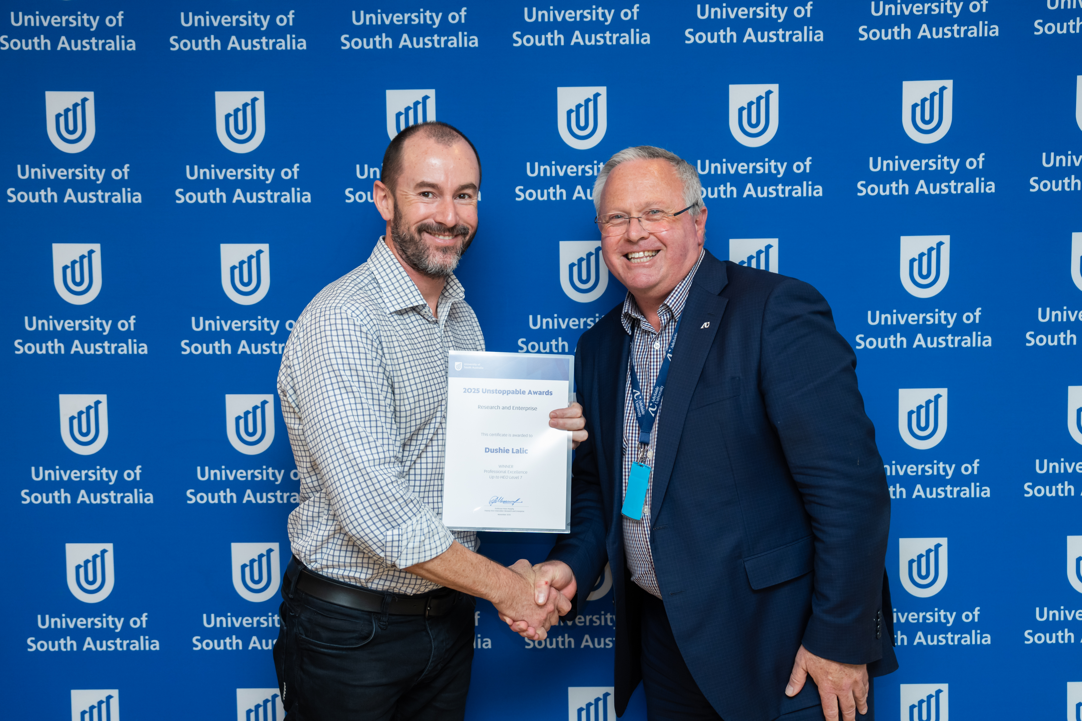 Professor Sam Sellar, Dean of Research in UniSA Education Futures, accepts the Up to HEO Level 7 Award on behalf of Dushie Lalic from Deputy Vice Chancellor: Research & Enterprise, Professor Peter Murphy