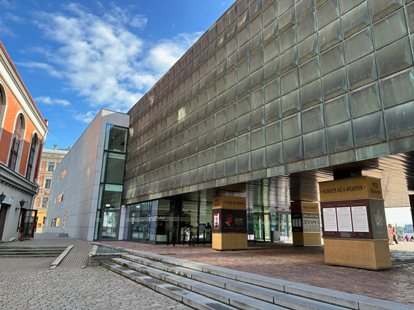 An open-air exhibition entitled “Hunger as a Weapon” sits under the brutalist Soviet building repurposed as the Museum of Occupation in the Latvian capital of Riga.