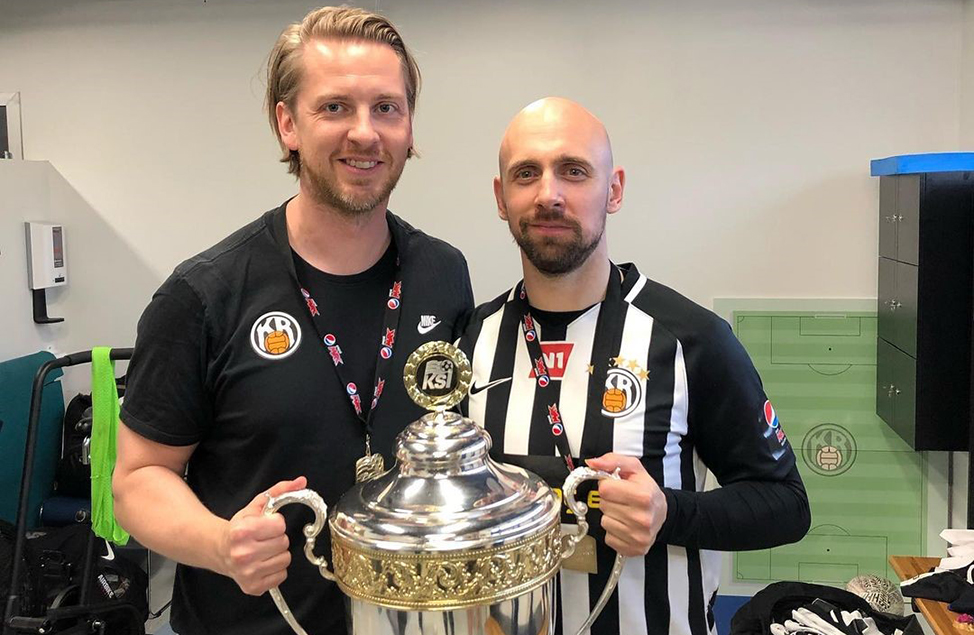 physiotherapist Valgeir Vi&eth;arsson holding 2019 &Uacute;rvalsdeild Icelandic Championship cup with team member