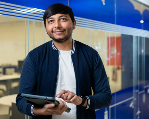 Young man typing on a tablet