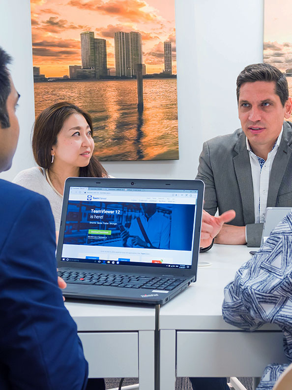 A researcher working in front of several screens