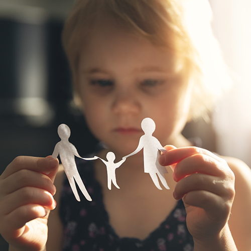 Child with paper cut-out family