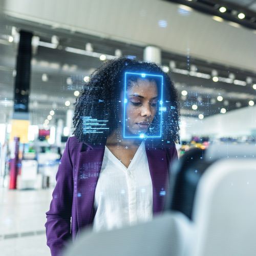 woman passing through biometric screening at airport