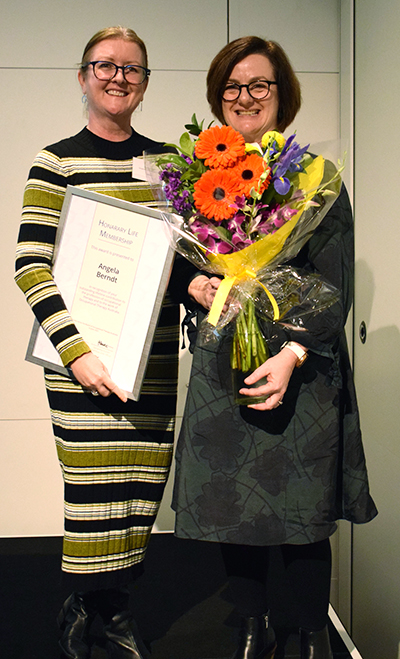 Professor Stacey George presents Dr Angela Berndt (L) with Occupational Therapy Australia&rsquo;s Lifetime Achievement Award.