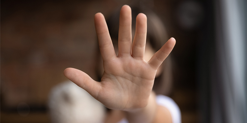 Close up of little girl child stretch hand show no gesture protest against child abuse.