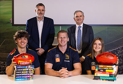 Crows CEO Tim Silvers (left, back) and Executive Dean UniSA Business Professor Andrew Beer (right, back), with high school students Thomas Mansfield (left), Ella Litchfield (right) and Crows player Reilly O&rsquo;Brien.